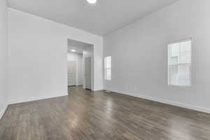 Unfurnished room with dark hardwood / wood-style flooring