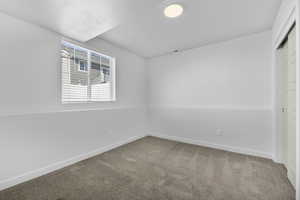 Unfurnished room featuring carpet flooring