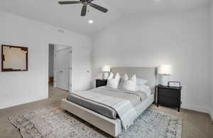 Carpeted bedroom with lofted ceiling and ceiling fan