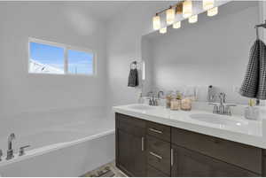 Bathroom featuring vanity and a bath