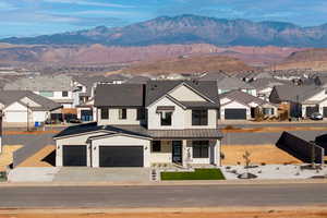 View of front facade featuring a mountain view and a garage