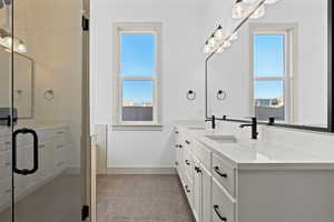 Bathroom featuring vanity and a shower with shower door