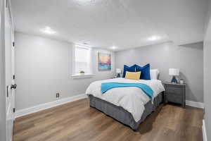 Bedroom featuring dark hardwood / wood-style floors and a textured ceiling