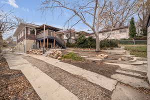 View of front of house featuring a wooden deck