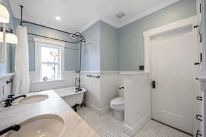 Bathroom with toilet, ornamental molding, vanity, a tub, and tile patterned flooring