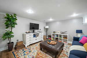 Living room with hardwood / wood-style flooring