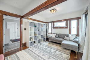 Living area with dark hardwood / wood-style flooring