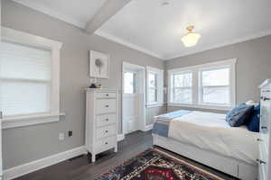 Bedroom with crown molding, dark hardwood / wood-style floors, and beam ceiling