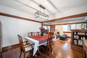 Dining space with dark wood-type flooring