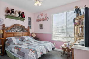 Carpeted bedroom with ceiling fan