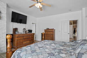 Bedroom with hardwood / wood-style floors and ceiling fan