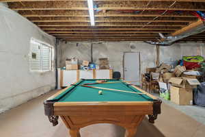 Playroom with billiards and concrete flooring