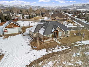 Snowy aerial view featuring a mountain view