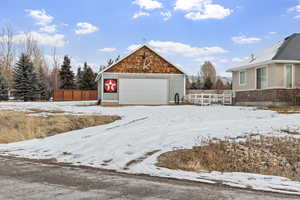 Exterior space featuring a garage and an outdoor structure