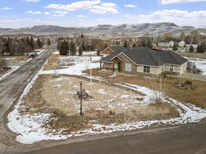 Snowy aerial view featuring a mountain view