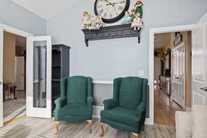 Sitting room with wood-type flooring