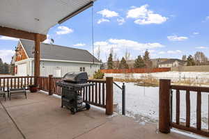 Snow covered patio with grilling area