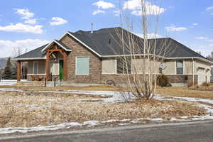 View of front of home with a garage and covered porch