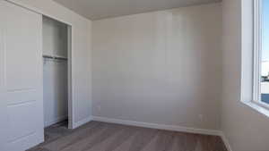 Unfurnished bedroom with a closet, baseboards, and carpet flooring
