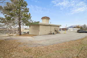 Rear view of property with cooling unit and a mountain view