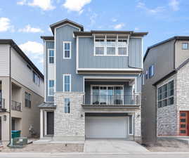 View of front facade with a garage and a balcony