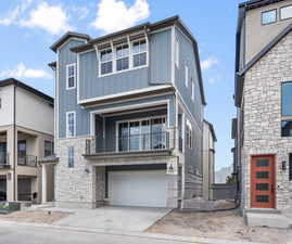 View of front of house with a balcony and a garage