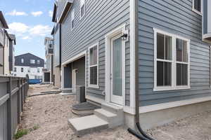 View of side of home with central AC