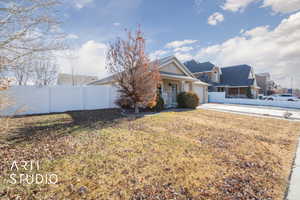 View of front of house featuring a garage and a front yard