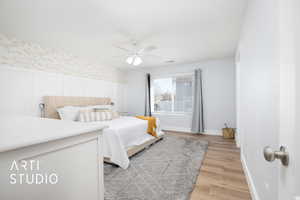 Bedroom featuring ceiling fan and light hardwood / wood-style floors