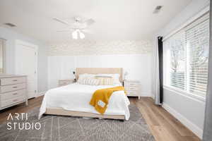 Bedroom with ceiling fan and hardwood / wood-style floors