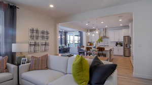 Living room featuring sink and light hardwood / wood-style floors