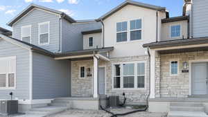 View of front of home featuring cooling unit