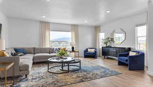 Living room featuring light hardwood / wood-style floors and a textured ceiling