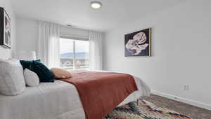 Carpeted bedroom with a mountain view and a textured ceiling