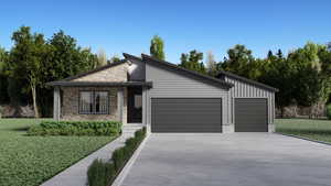 View of front of home with a garage and a front lawn