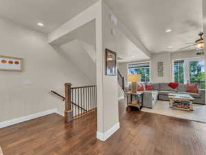 Living area featuring ceiling fan, wood-type flooring, baseboards, and recessed lighting