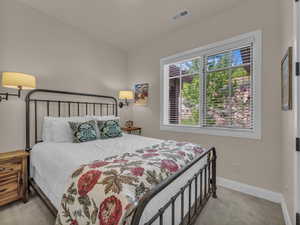 Carpeted bedroom with baseboards