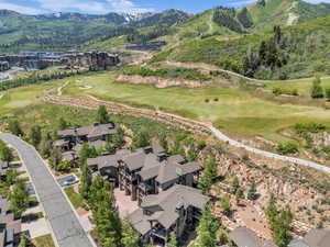 View of property location with a mountainous background and a golf course