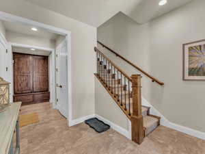 Staircase featuring baseboards and recessed lighting