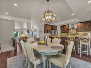 Dining area with a chandelier, wood finished floors, and recessed lighting