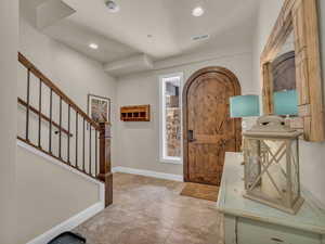 Foyer entrance featuring stairway, recessed lighting, and baseboards