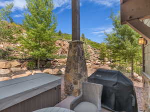 View of patio / terrace with area for grilling and a hot tub