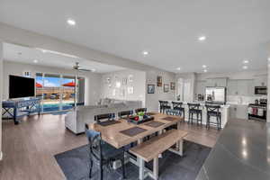 Dining area featuring dark wood-type flooring and ceiling fan