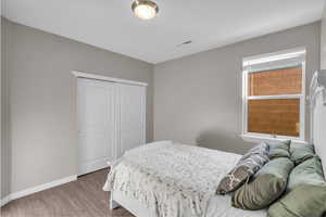 Bedroom featuring hardwood / wood-style floors and a closet