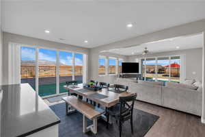 Dining room with ceiling fan and dark hardwood / wood-style flooring