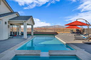 View of pool featuring a mountain view and a patio area