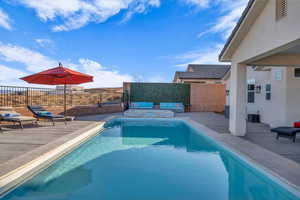 View of pool featuring cooling unit and a patio area