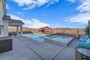 View of swimming pool with an in ground hot tub, a mountain view, outdoor lounge area, and a patio area