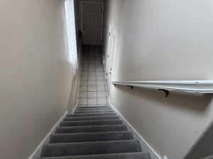 Staircase with tile patterned floors