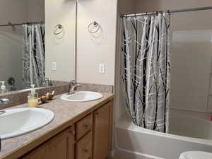 Master Bathroom featuring vanity and shower/bath combination with curtain